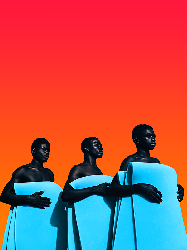 3 African men holding blue blankets against an orange background