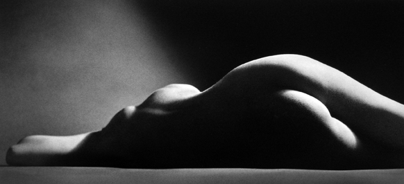 Black-and-white nude of a female model seen from the back