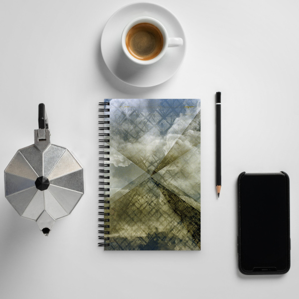 Notebook with a coffee cup, pencil and cell phone on a table