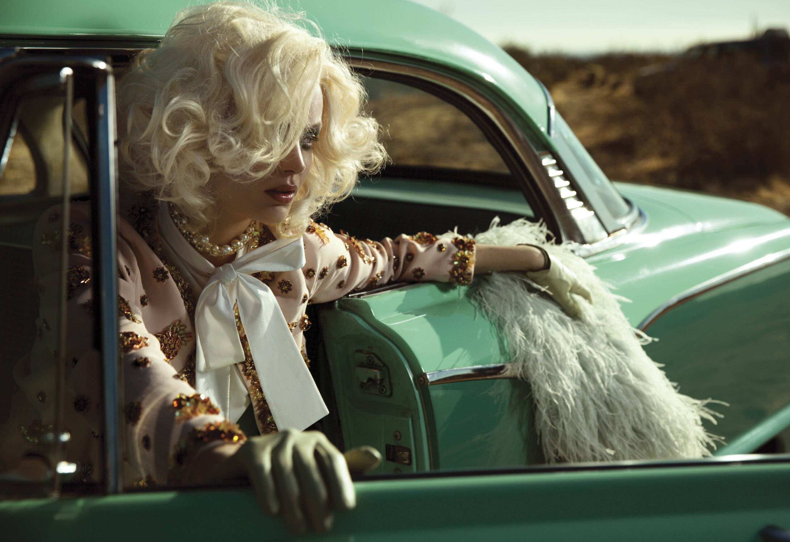 Woman in a vintage car in the desert
