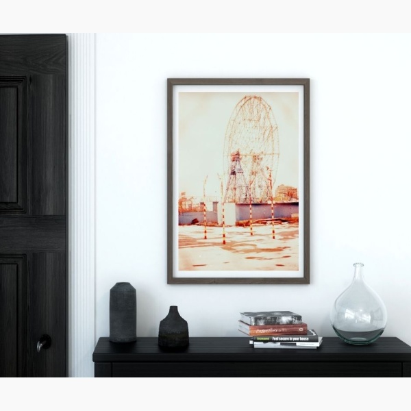 Print of Coney Island, hanging above a console table