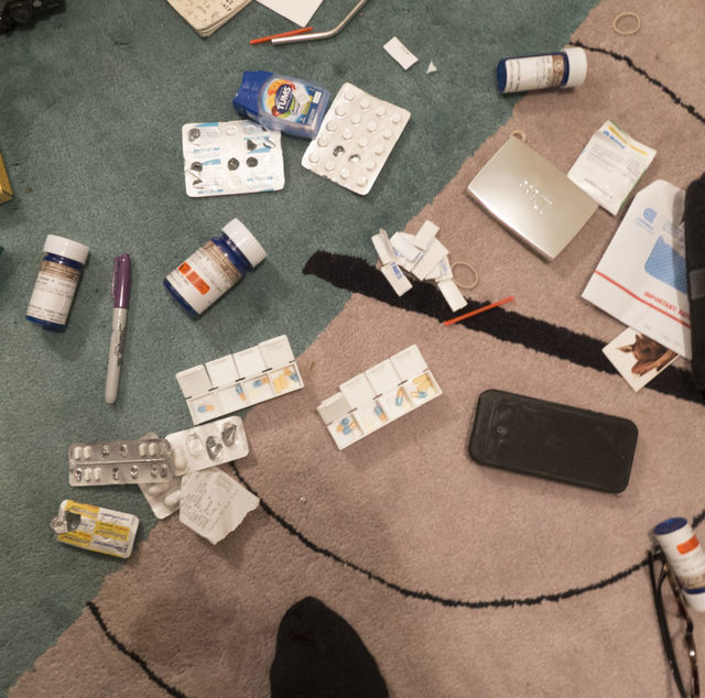 Glass table in a living room, covered with drug paraphernalia