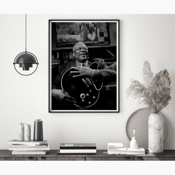 Framed portrait of legendary blues musician BB King, hanging above a console table