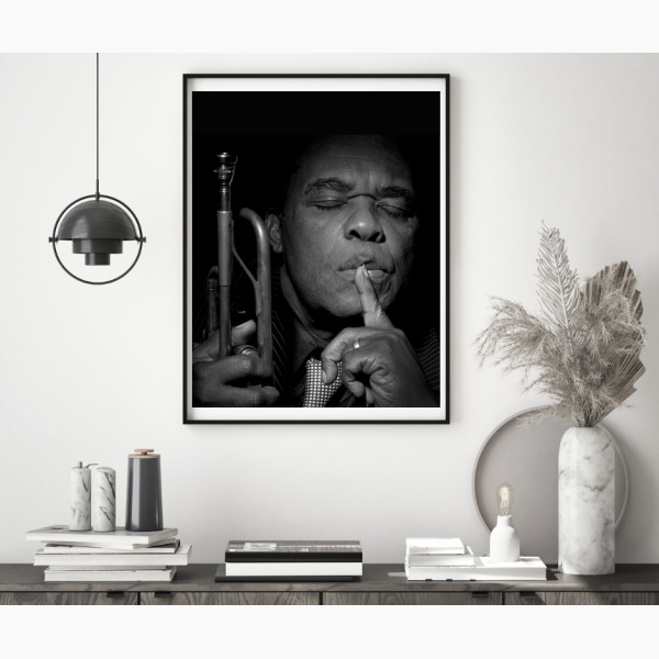 Framed print of Freddie Hubbard, hanging above a console table