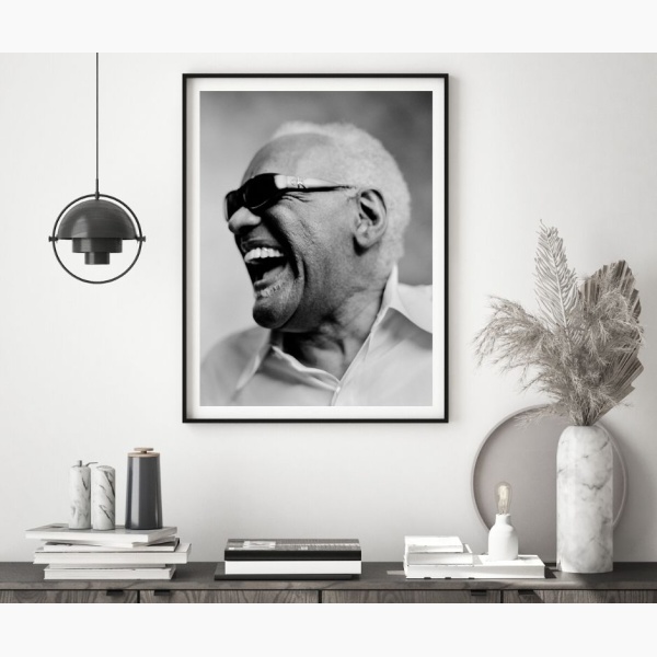Framed portrait of Ray Charles hanging above a console table