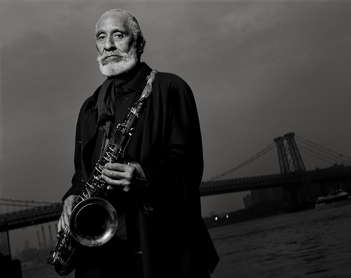 Sonny Rollins with his saxophone in front of the Williamsburg's Bridge