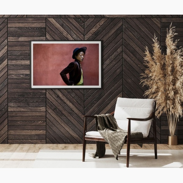 Framed print of a black woman's portrait, hanging in a reading nook
