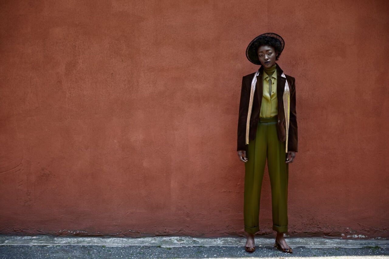 Female model standing against a wall