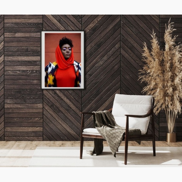 Framed print of a black woman's portrait, hanging in a reading nook