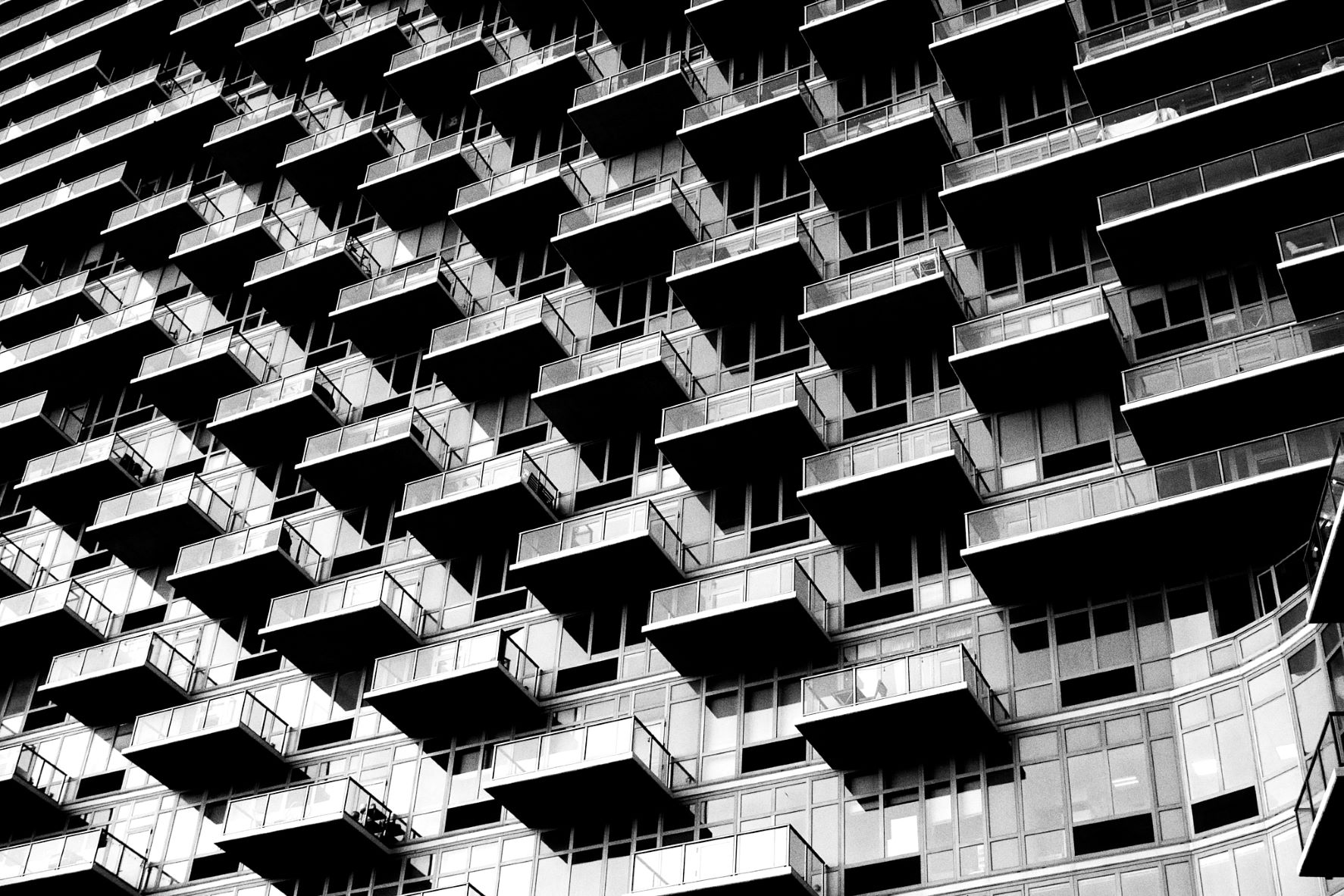 Large view of a skyscraper façade, covered with glass balconies