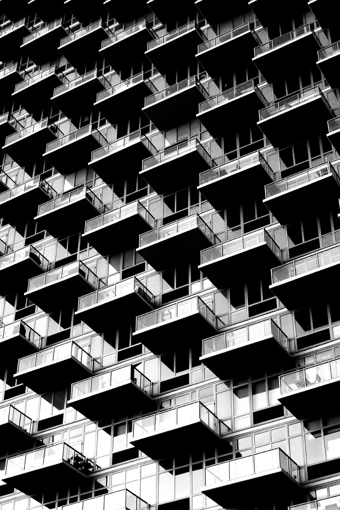 Close up of a skyscraper façade, covered with glass balconies