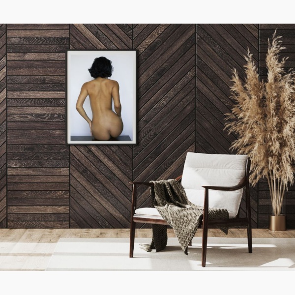 Framed print of Close-up of a naked woman seen from the back, hanging in a reading nook