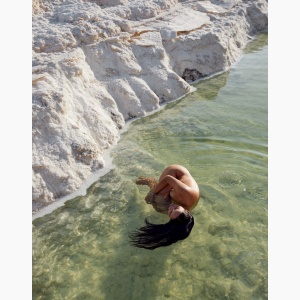 Nude woman floating in a salt lake