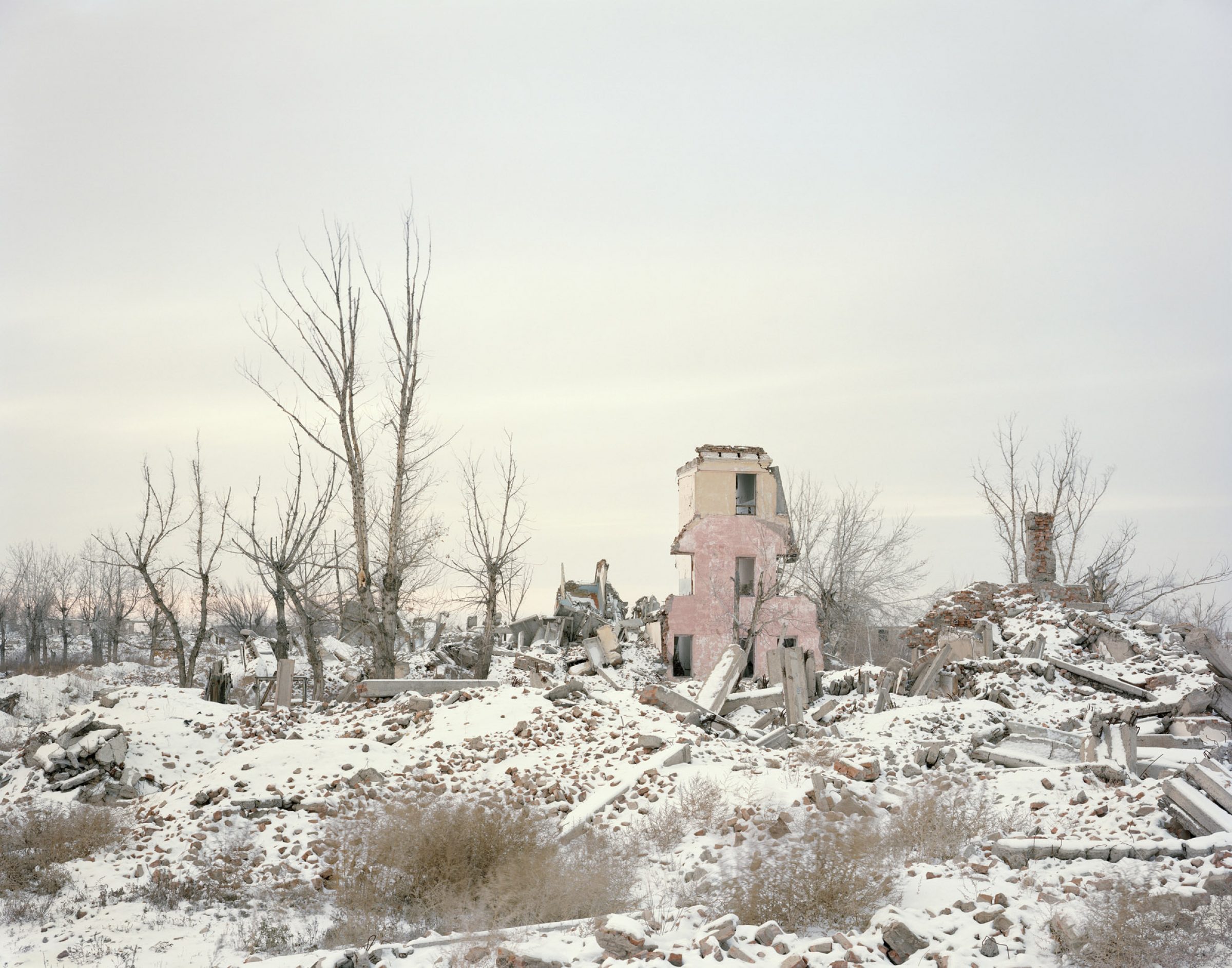 Deserted research facility building, half fallen in ruins