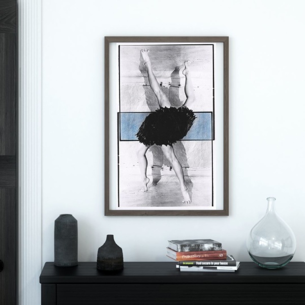 Framed print of a collage print showing ballet dancers' legs, hanging above a console table
