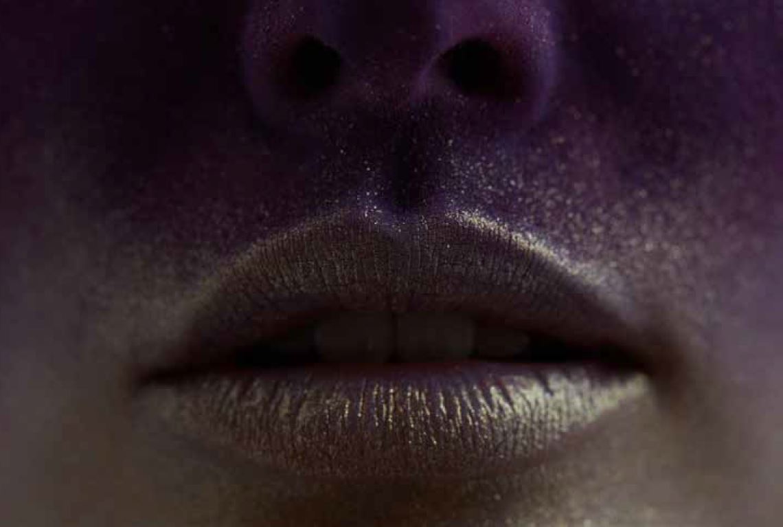 Close-up of a woman's mouth covered in glitter