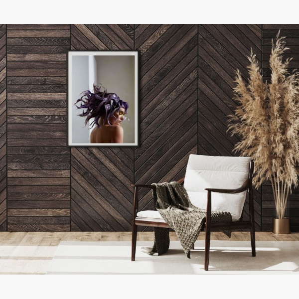 Framed print of a woman with purple tentacles-like hair hanging in a reading nook corner