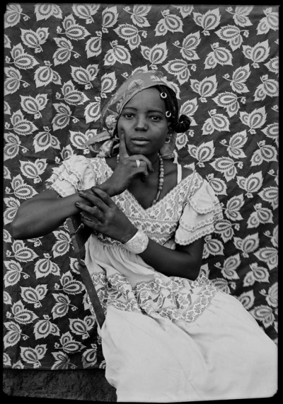 Formal portrait of a younf Malian woman, sitting on a chair