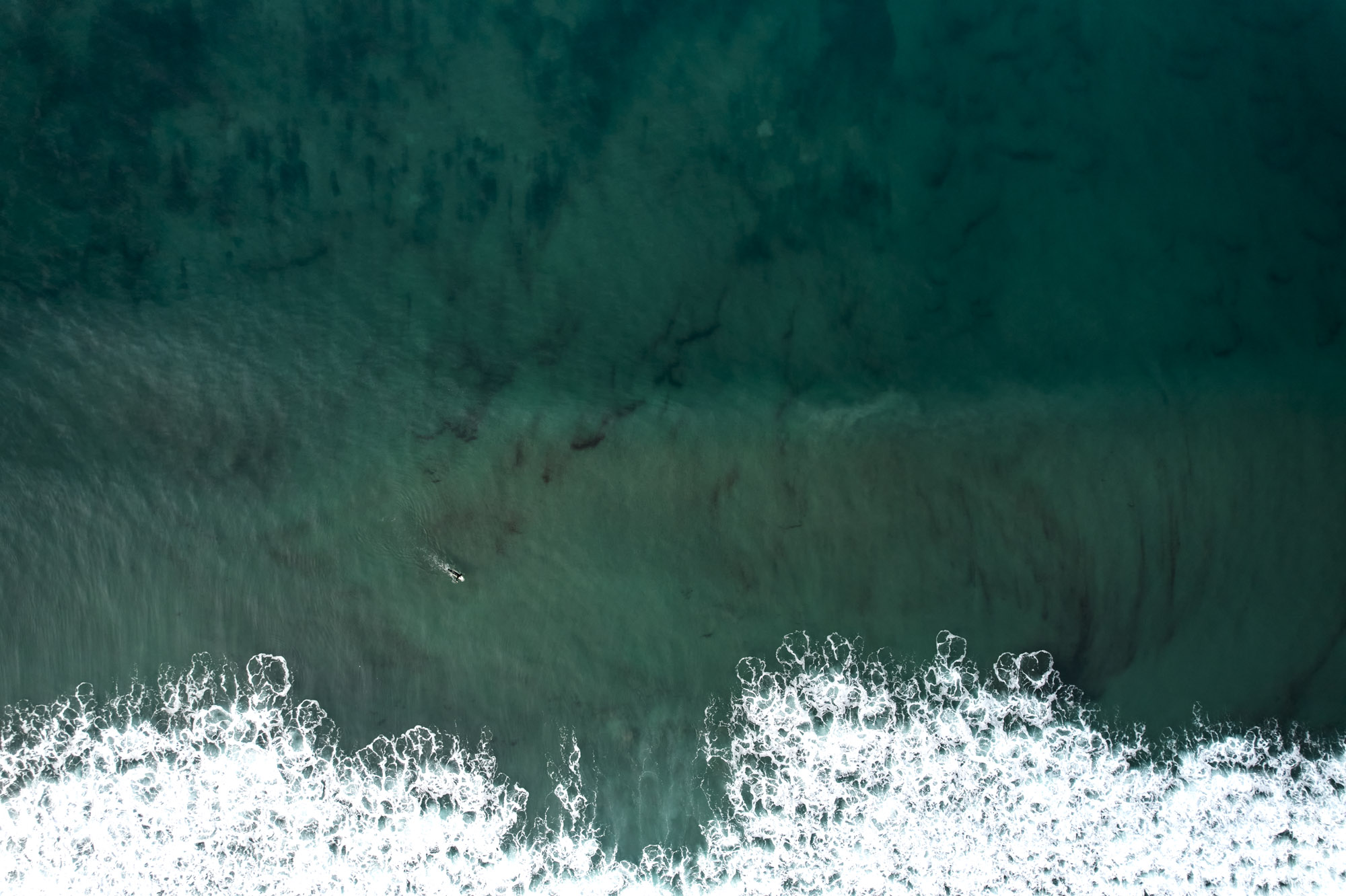 Limited edition print of an aerial photography of a surfer, seen from high above