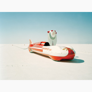 A streamliner racing car stopped on a salt flat