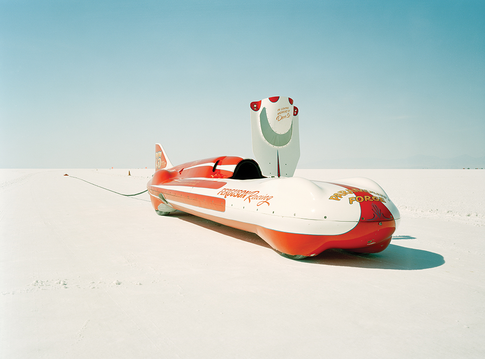 A streamliner racing car stopped on a salt flat