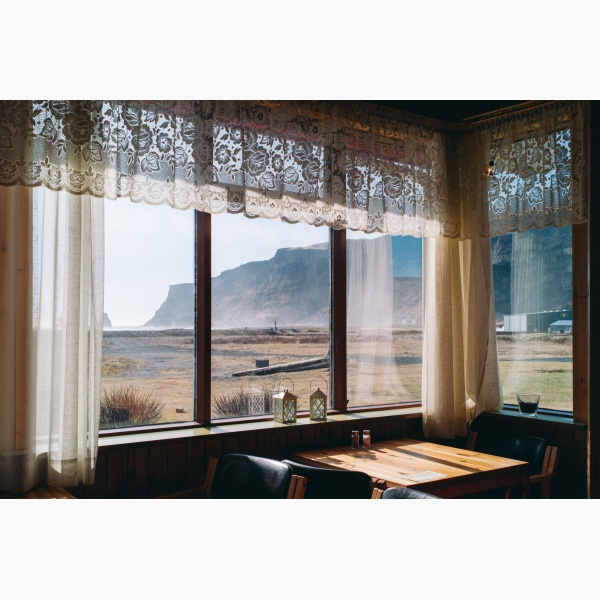 Limited edition print of an empty diner with a grand landscape of mountains seen through its large windows