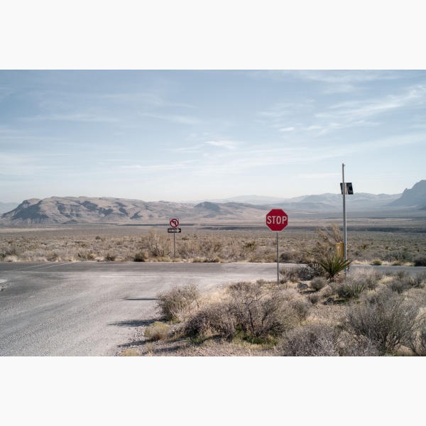 Limited edition print of a dusty desertic route with a stop sign standing at an intersection