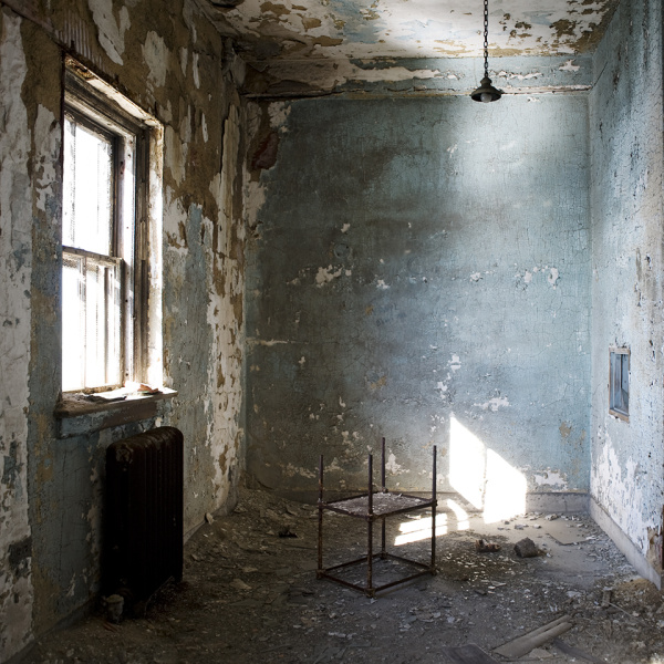 An abandoned room with a table and a window