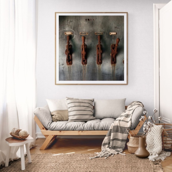 Large limited edition print of rusty remnants hangs in a cosy living room